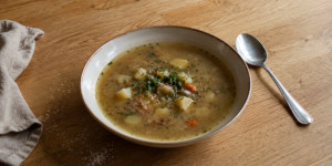 A bowl of Czech potato soup with mushrooms and root vegetables