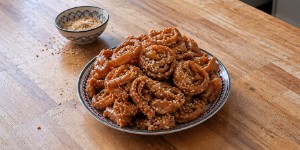 Golden Moroccan Chebakia pastries glazed with honey and sprinkled with sesame