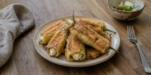Traditional Bulgarian Chushki Burek with roasted peppers stuffed with sirene cheese and fried in breadcrumbs