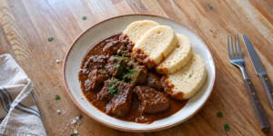 Czech beef goulash served with fresh onions and bread dumplings
