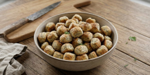Traditional Lithuanian Kūčiukai biscuits on a baking sheet