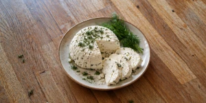 Lithuanian curd cheese sliced on a rustic wooden plate