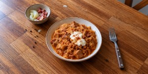 Hungarian Székelykáposzta pork and sauerkraut stew served with sour cream