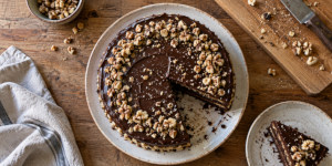 Traditional Bulgarian Garash cake with walnut layers and dark chocolate