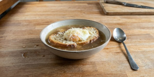 Traditional Zuppa alla Pavese with toasted bread, egg, Grana Padano and hot broth