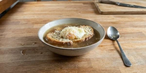 Traditional Zuppa alla Pavese with toasted bread, egg, Grana Padano and hot broth